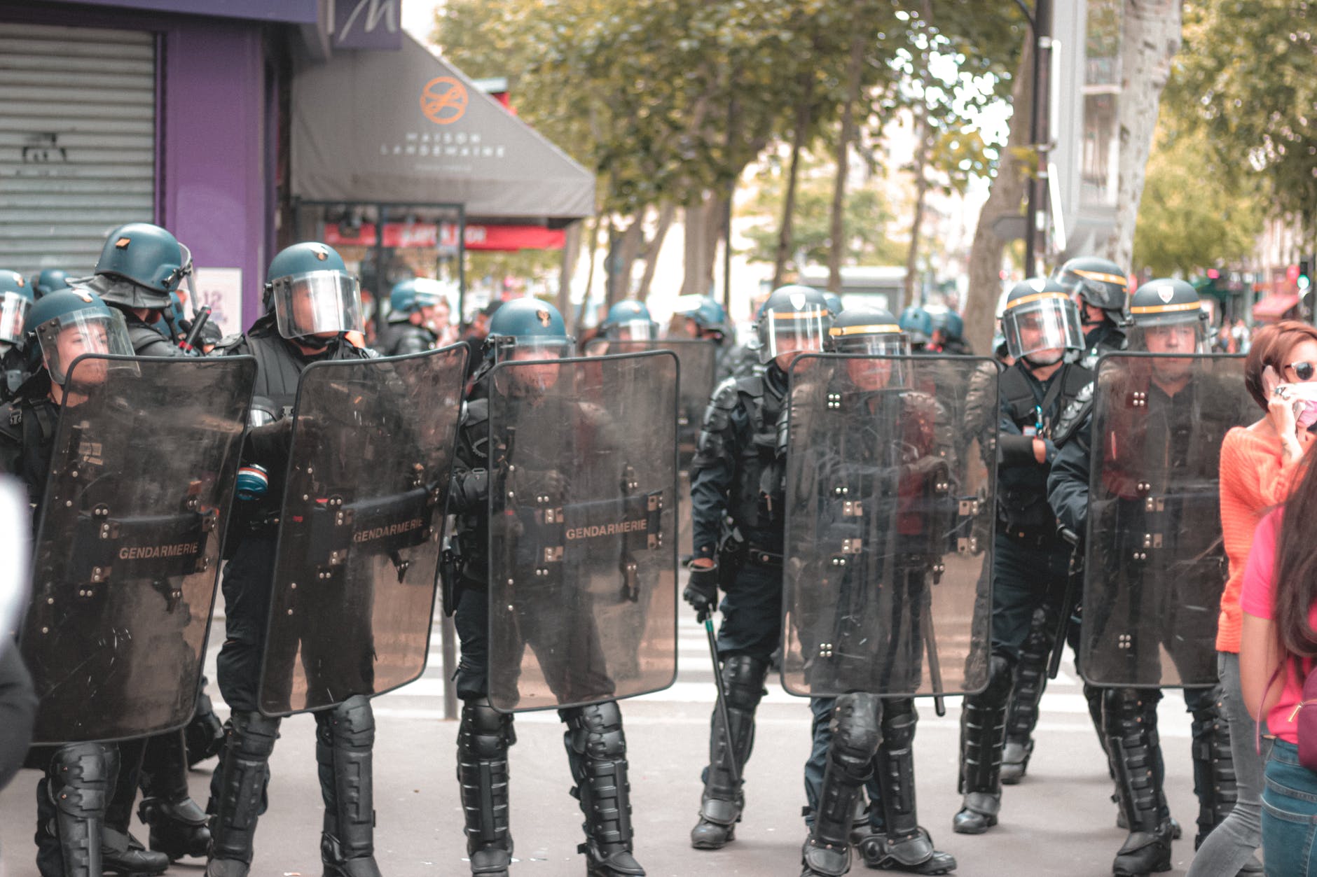 unrecognizable policemen standing on city street